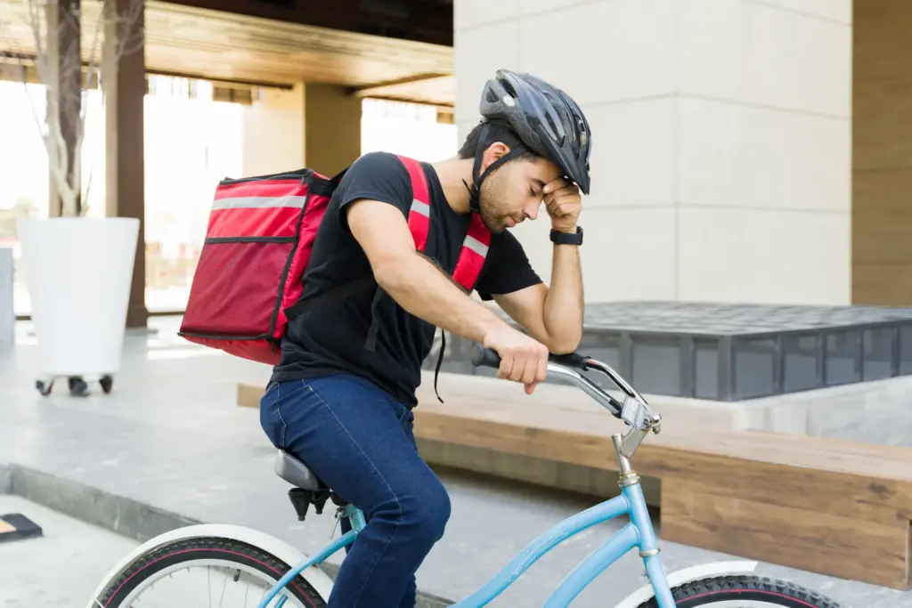 A tired food delivery biker.