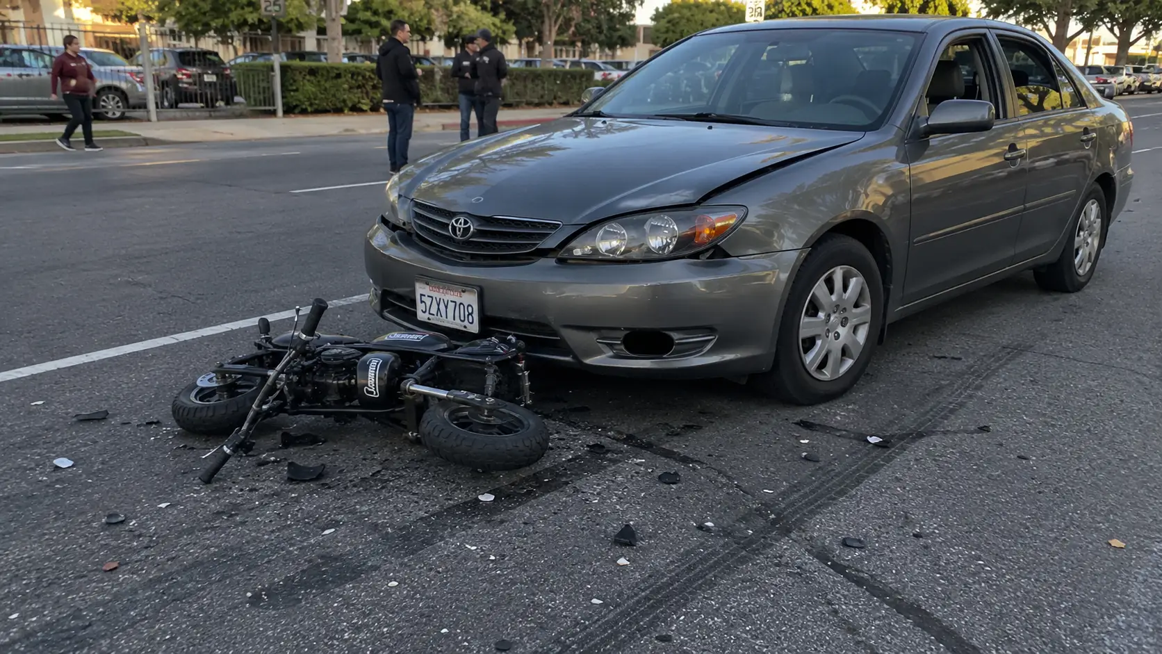 An accident scene involving a car and mini bike.