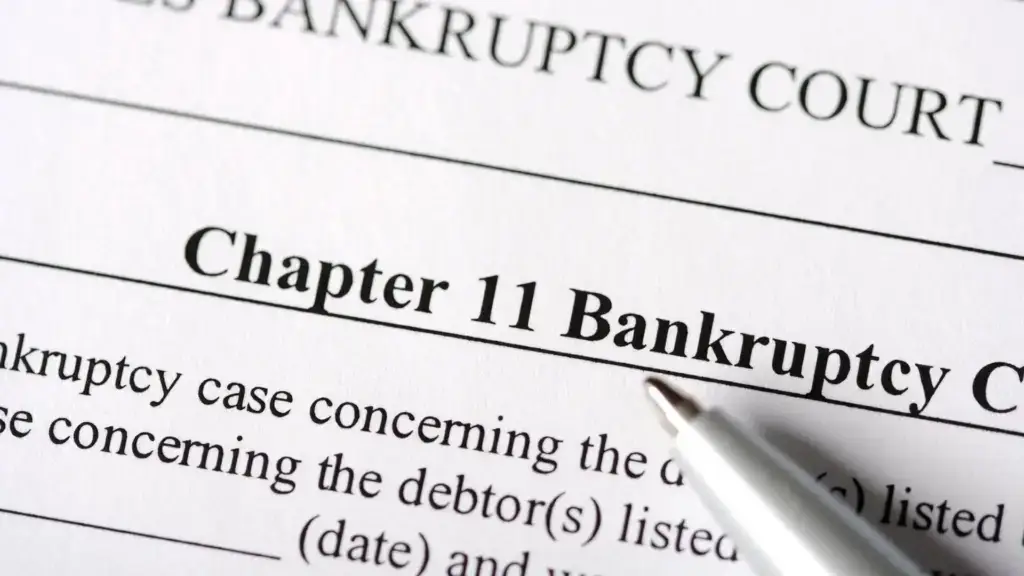 A Chapter 11 Bankruptcy Form with a pen.