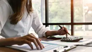 A woman calculating costs.