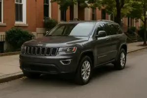 A dark gray Jeep Cherokee parked on the side of the street.