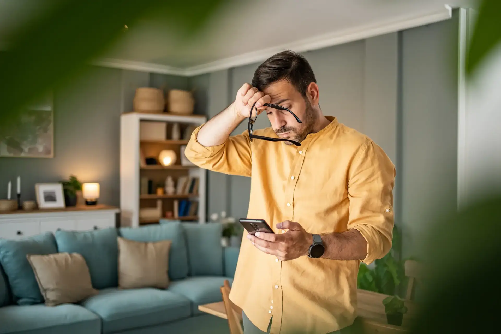 Un hombre mirando su teléfono con estrés.