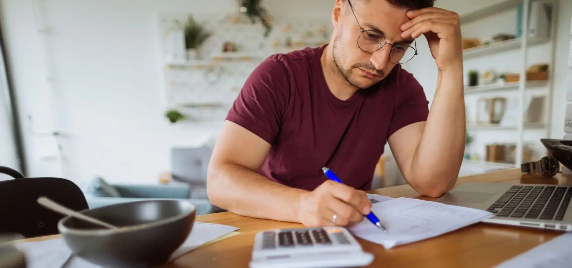 A man calculating his bills.