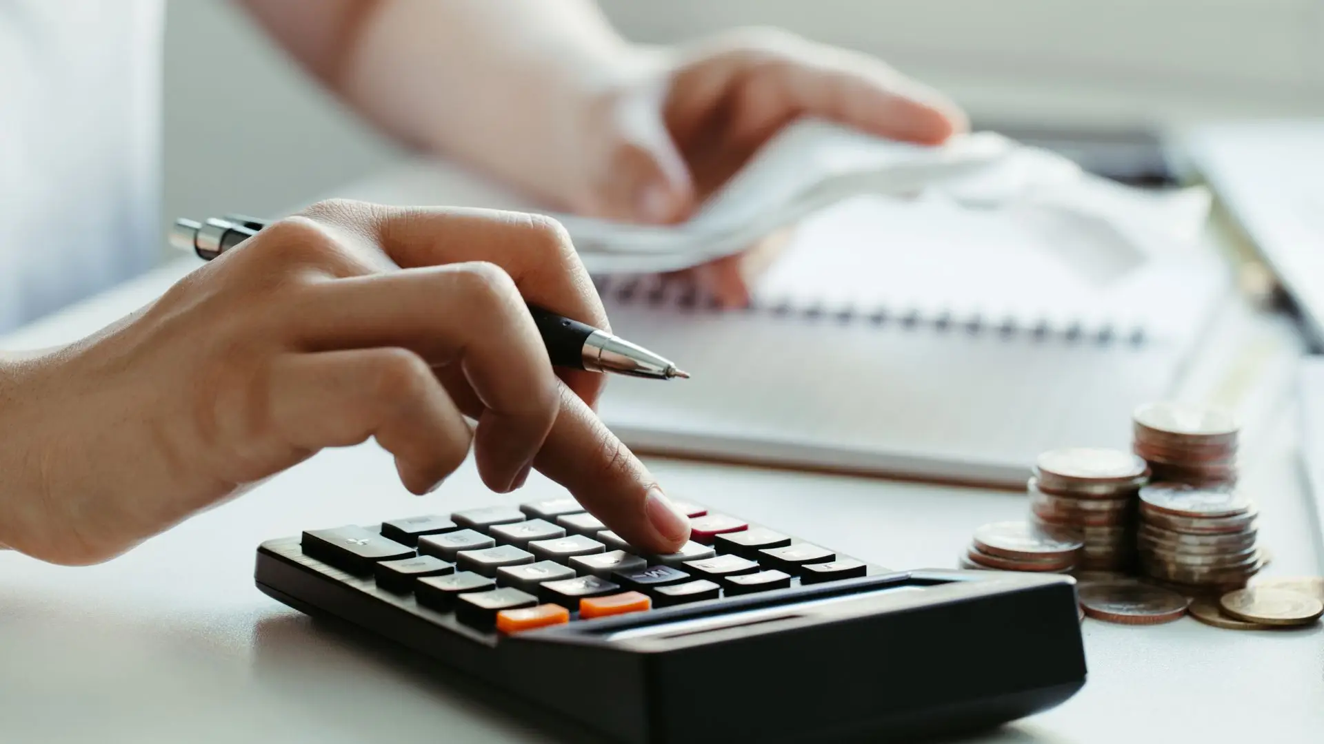 A person calculating their expenses.