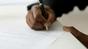 A person signing a document. 