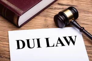 A paper saying "DUI LAW" next to a book and gavel. 