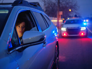 A woman getting pulled over by police. 