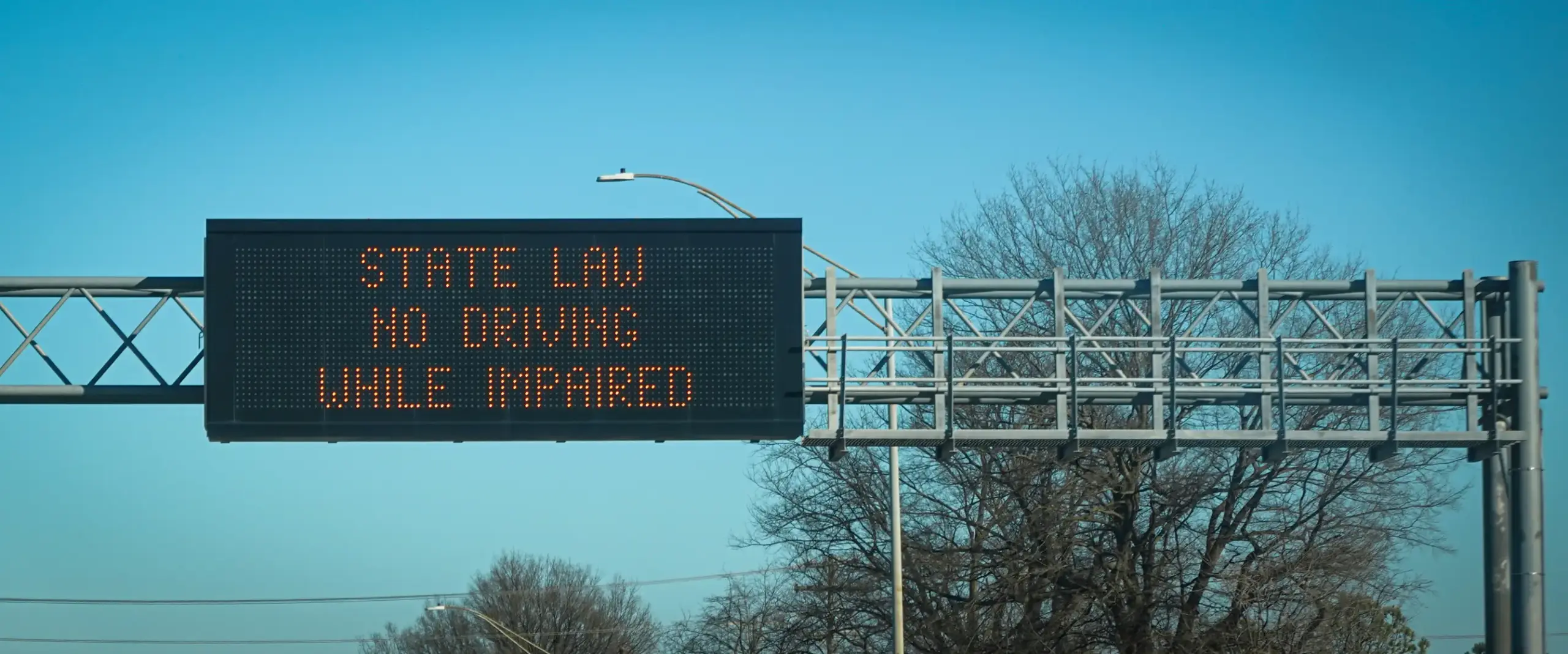 A Freeway sign warning people to not drive while under the influence. 