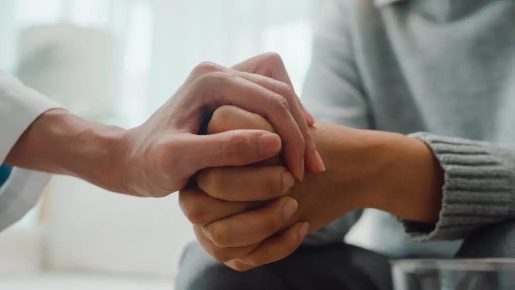 A person holding another person's gripping hands.