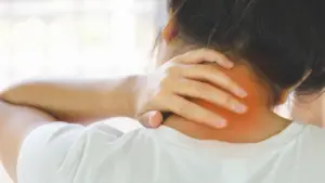 A person holding their neck in pain.