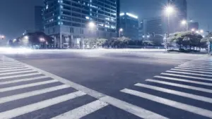A large empty intersection at night.