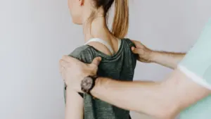 A doctor treating a woman's thoracic spine injury.