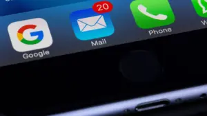 A smartphone showing a google app, an email app and a phone app. 