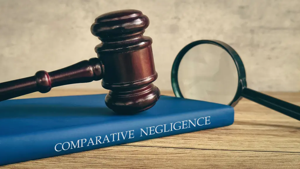 A Comparative Negligence book with a gavel on top of it.