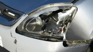 A car with a broken headlight.