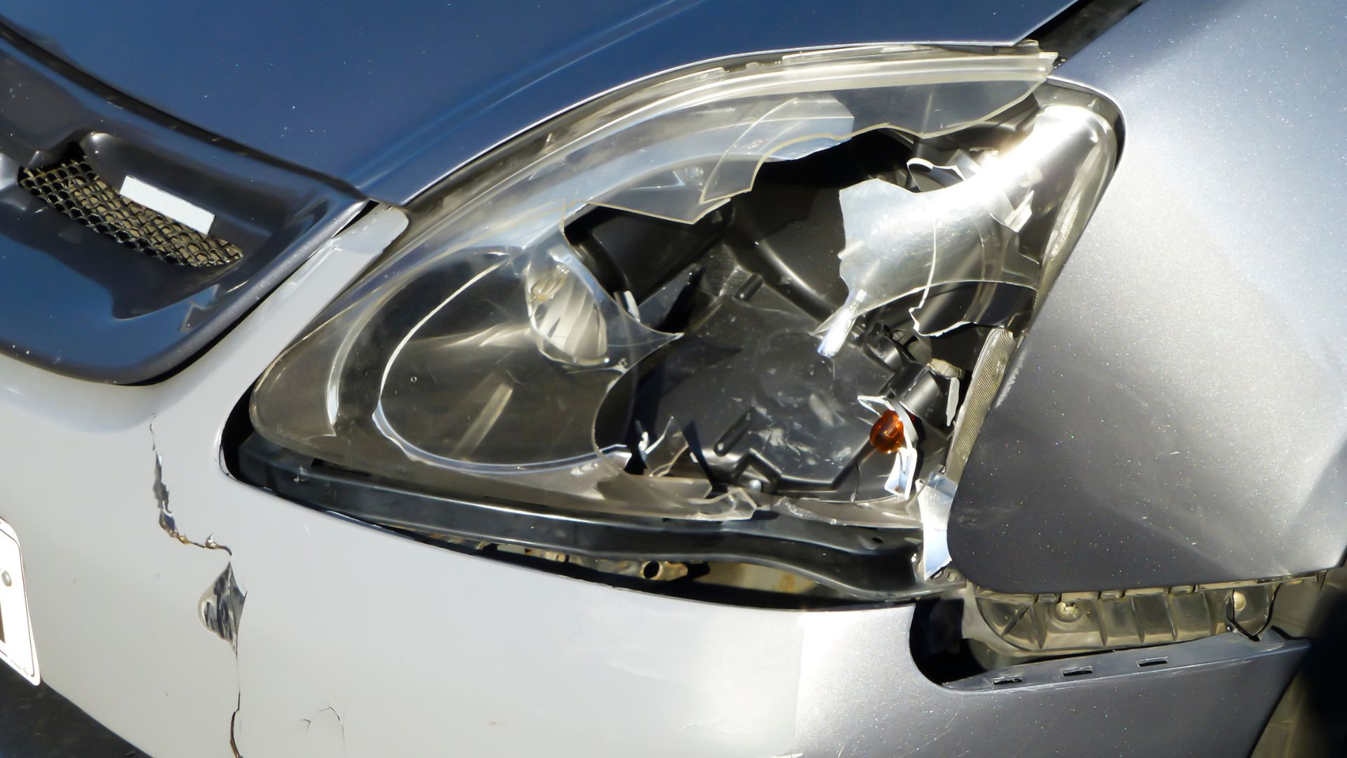 A car with a broken headlight.