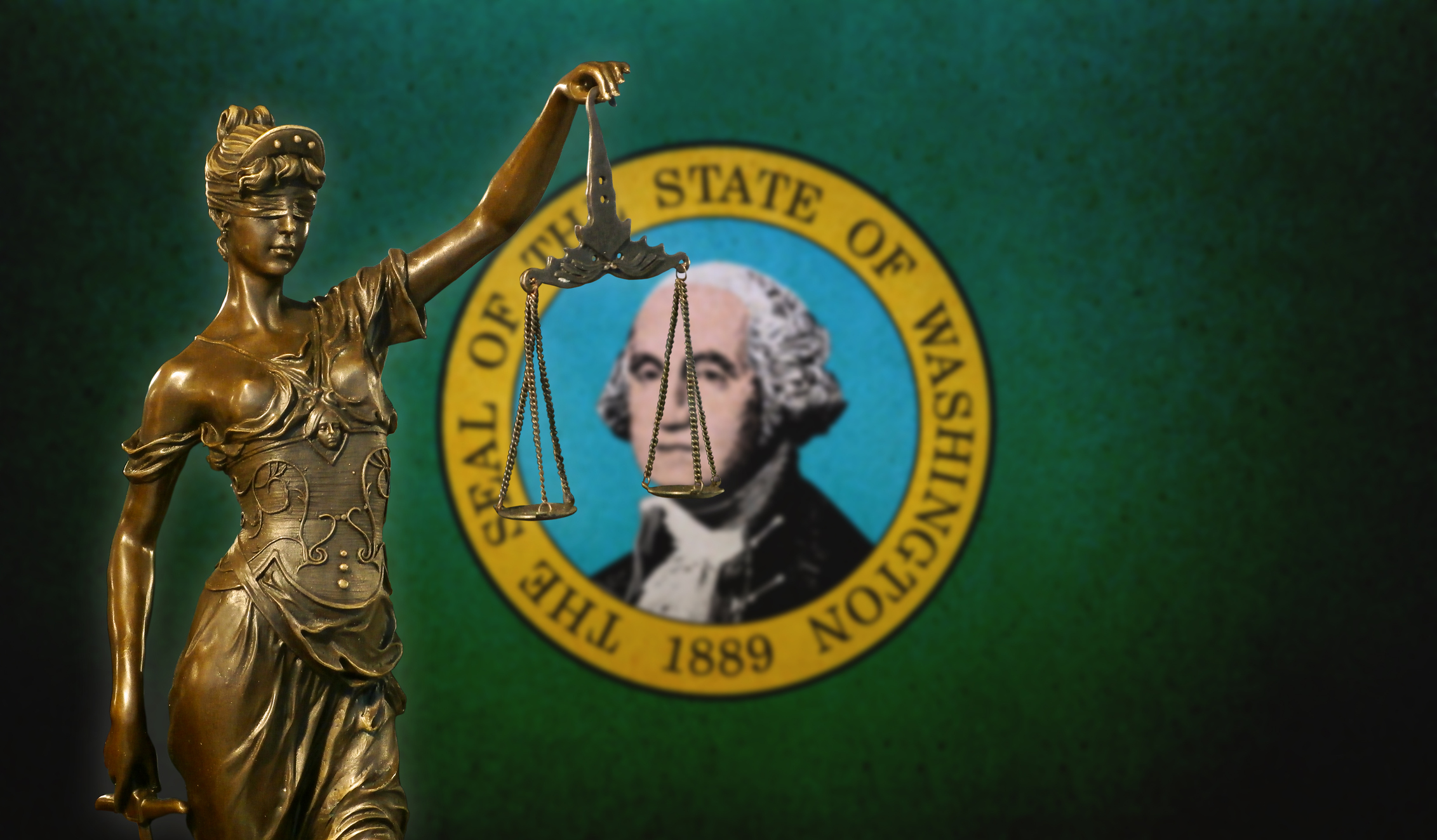A statue of lady justice in front the Washington State Flag.
