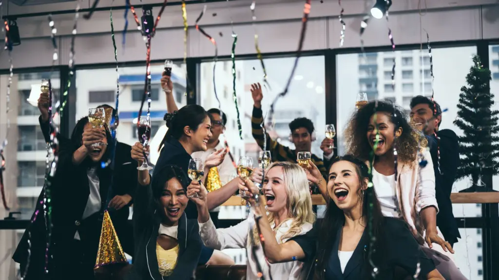 A holiday party celebrating with a toast.