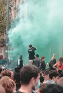 A picture of colored smoke during a protest.