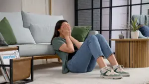 A woman crying in the living room.