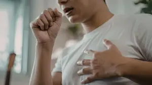 A person coughing at home.