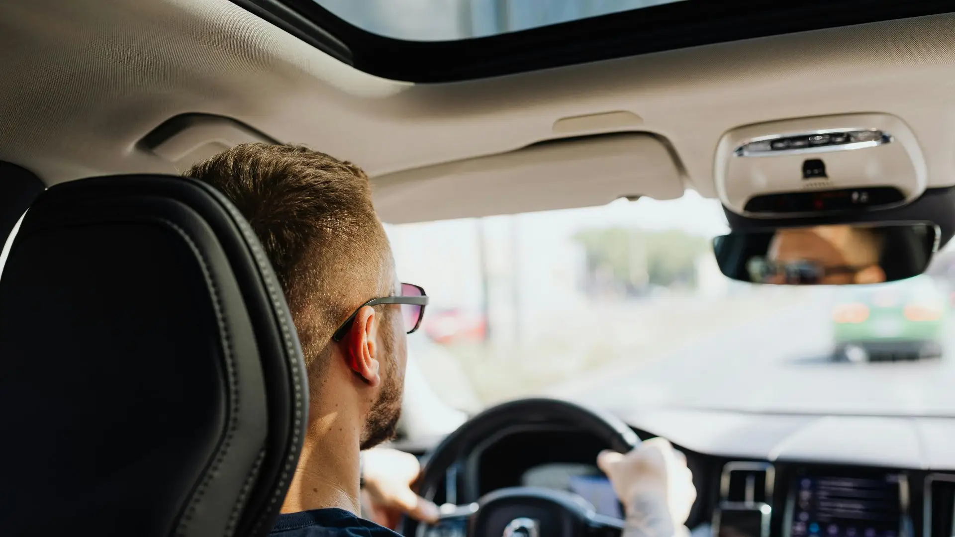 A person driving peacefully in his car.
