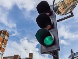 A close up of a traffic light in the city.