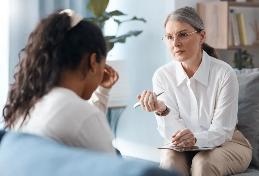 A therapist talking to a sexual assault victim.