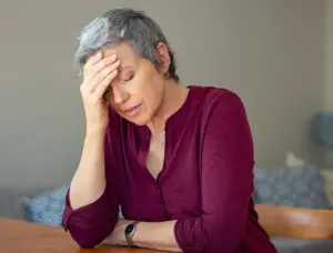 An old woman looking stressed.