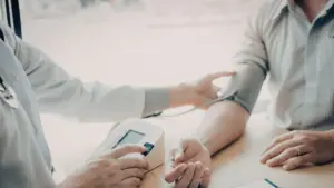 A doctor measuring a person's blood pressure.