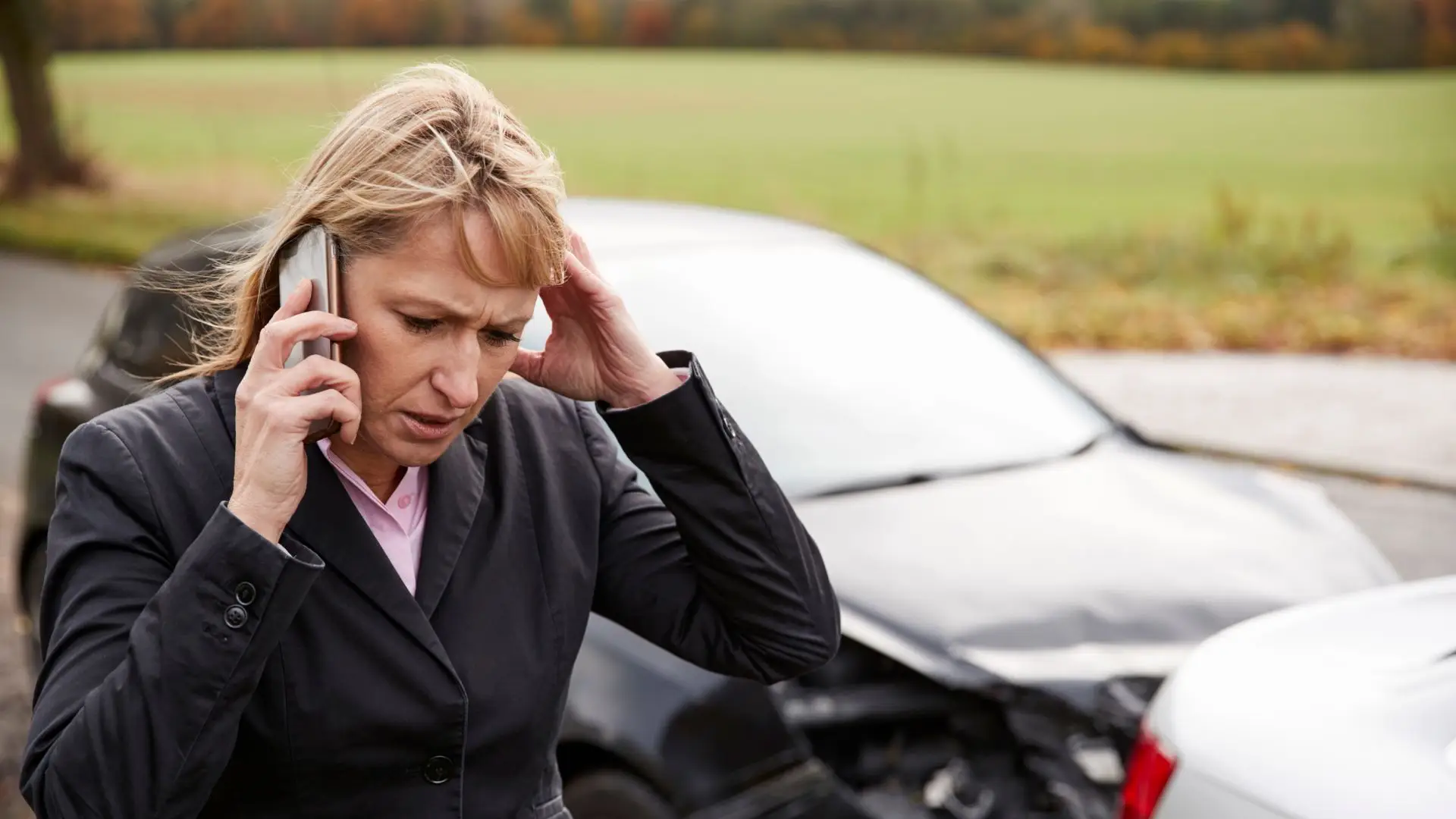 A woman calling her lawyer after a car accident.