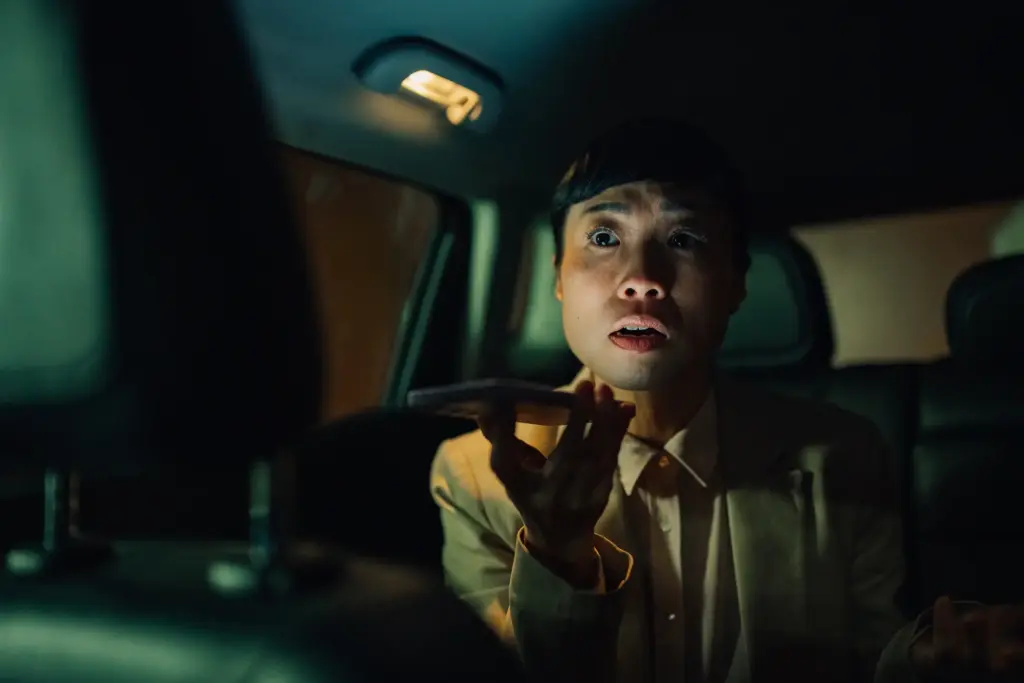 A scared rideshare passenger on the phone after an accident has happened.