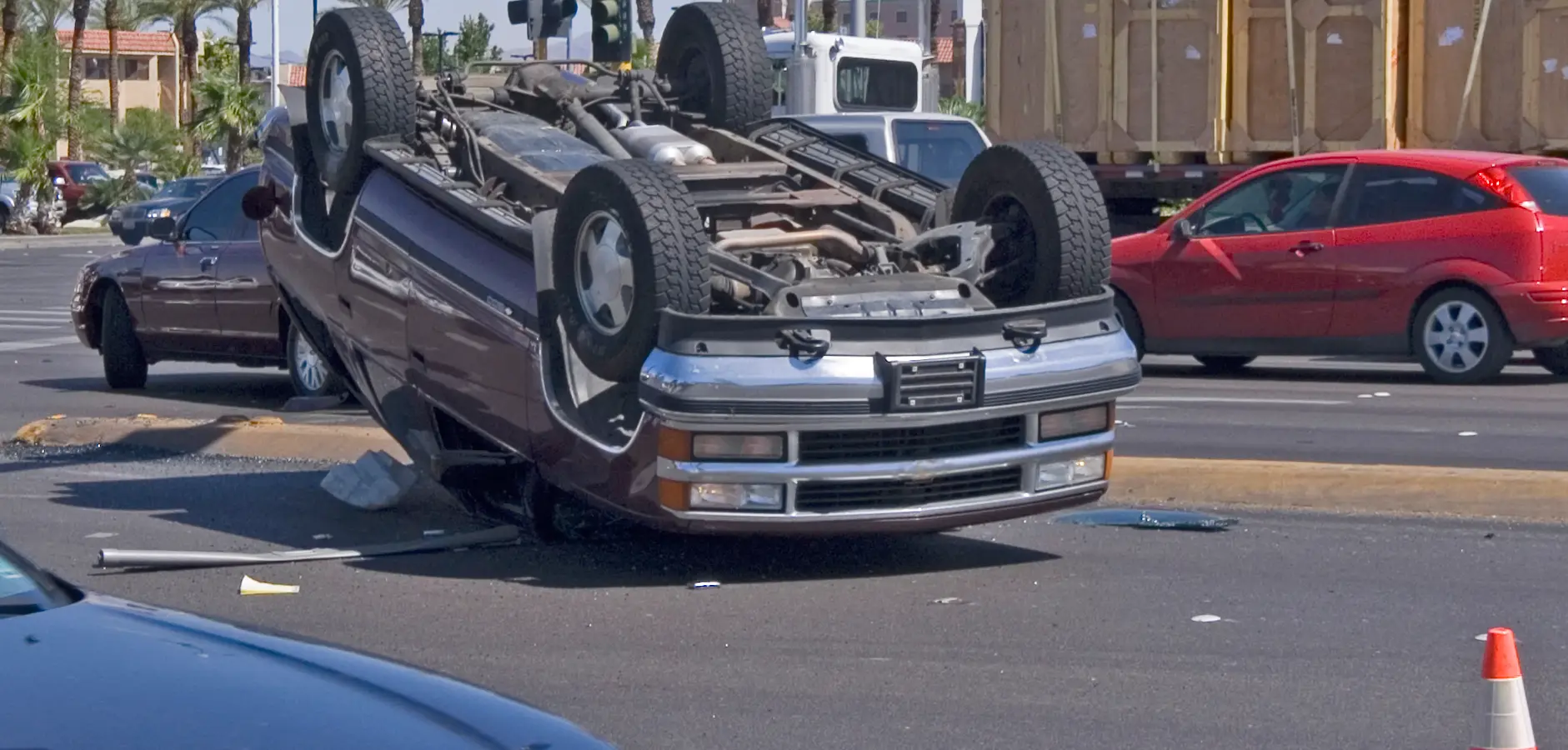 A flip over car in the middle of the street.