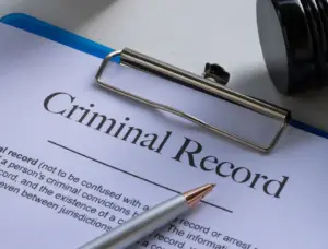 A clipboard with a criminal record paper on it.