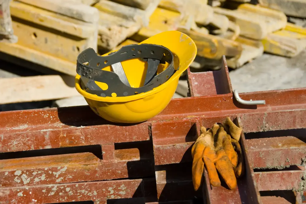 A hardhat on top of some materials at a construction site.