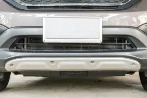 A close up of a blank license plate on a car.