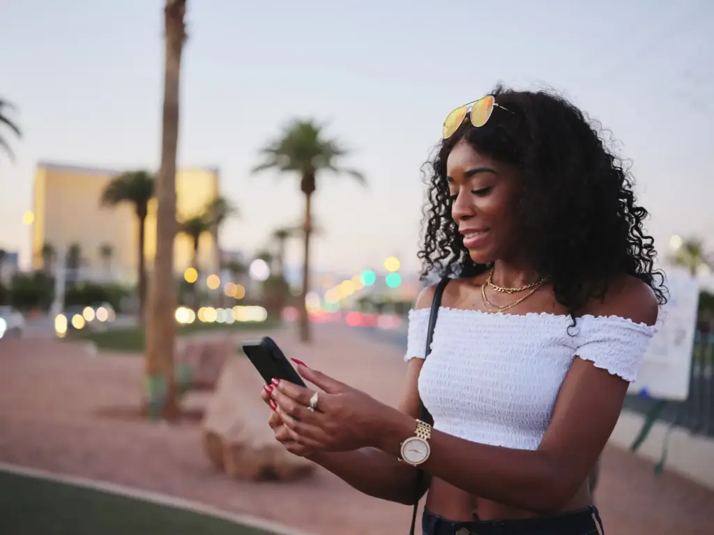 A tourist in Las Vegas looking through her phone.