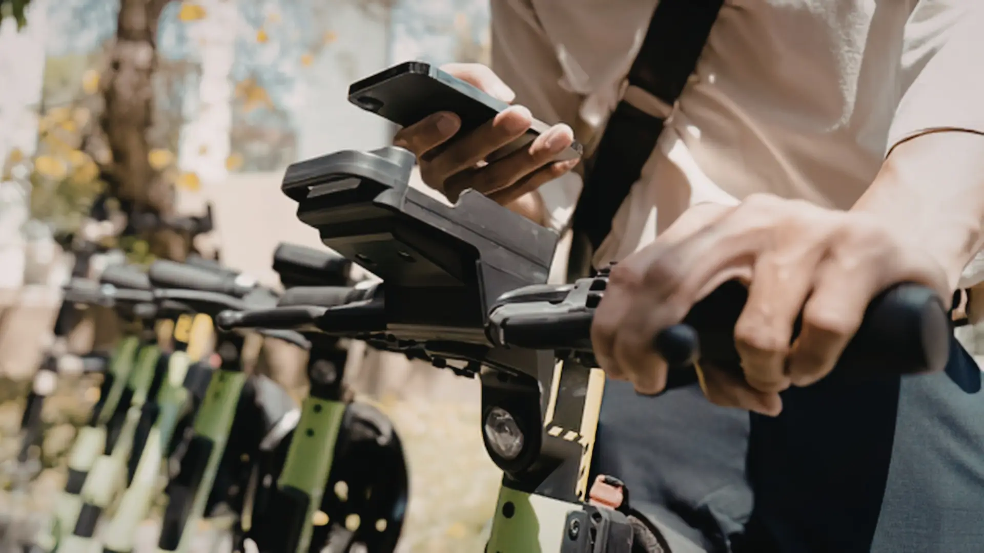 A person using an app to use a rental electric scooter.