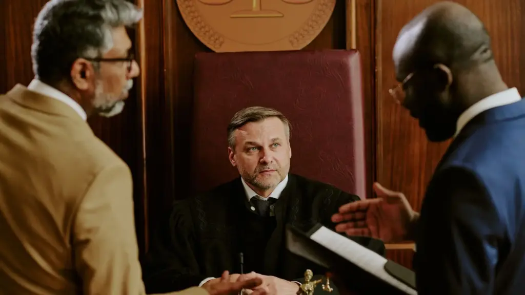 Two attorneys speaking to a judge about a case.