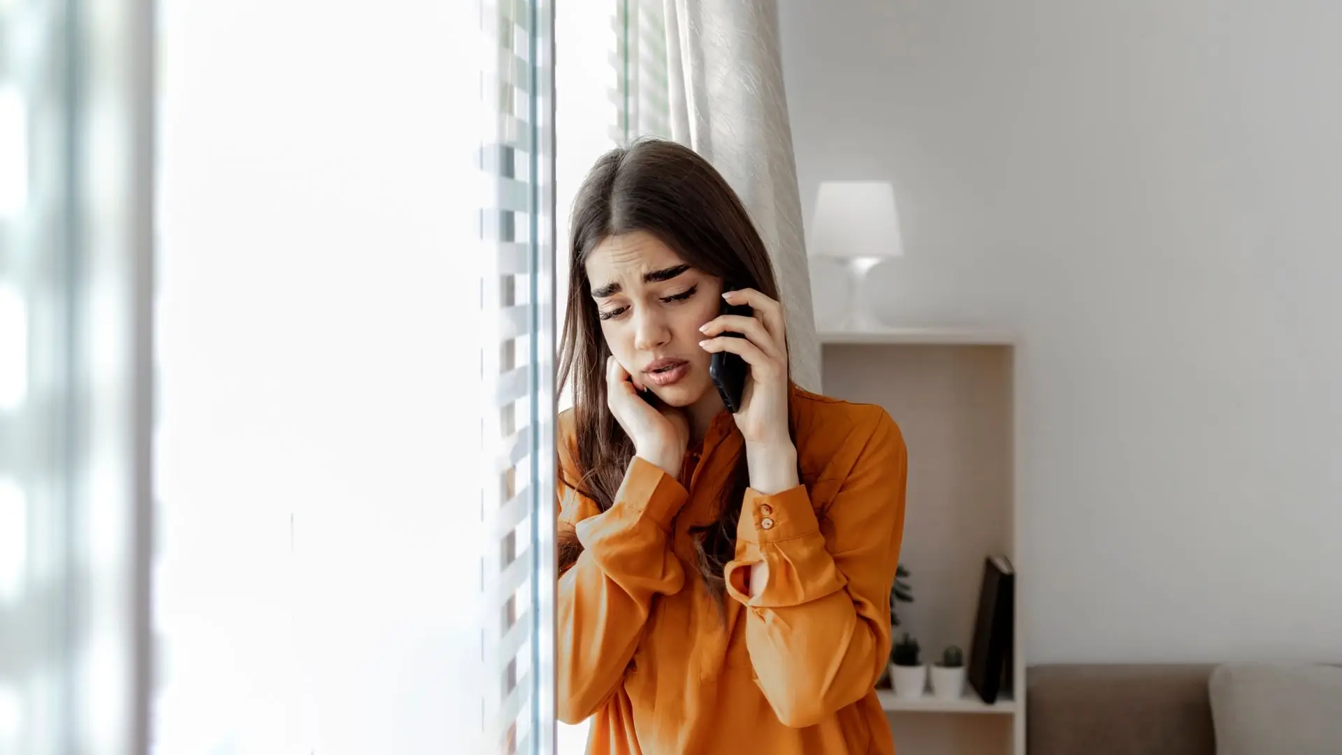 A troubled woman on the phone with a lawyer.