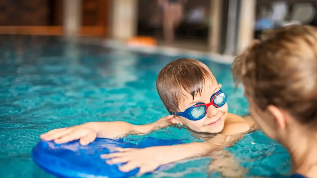 A parent teaching their child how to swim.