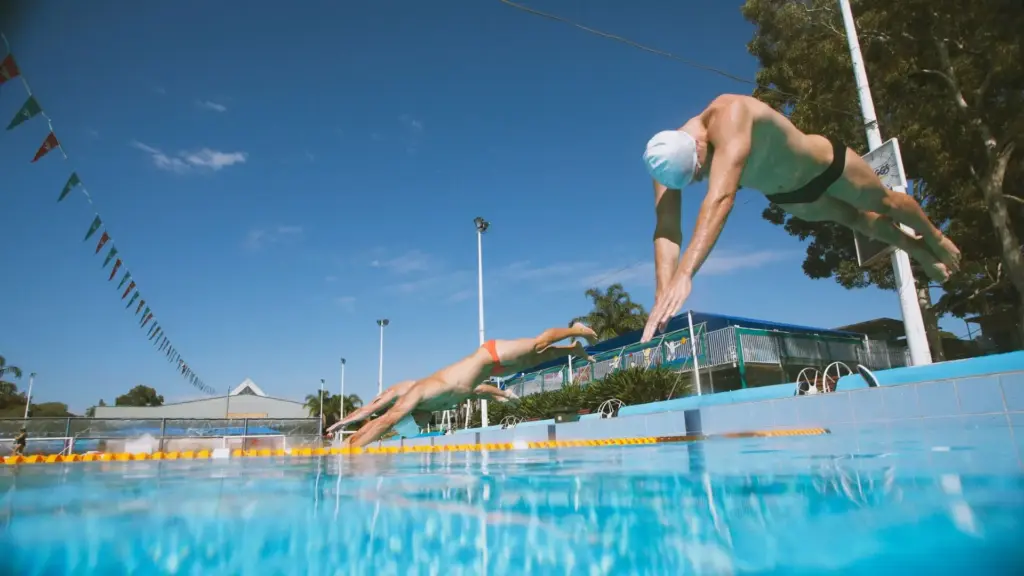 A row of divers jumping into the pool.