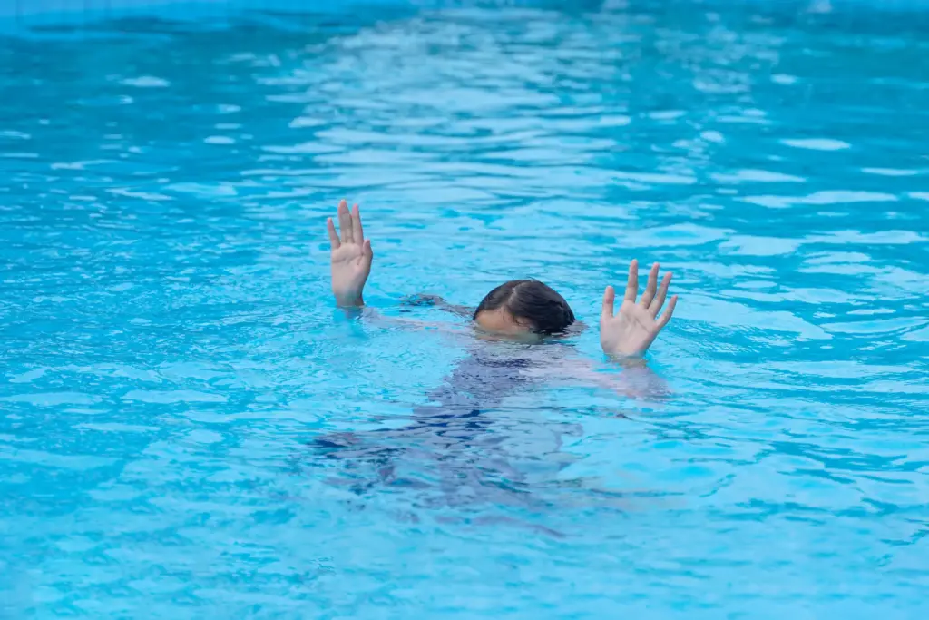 A girl drowning in a pool. 
