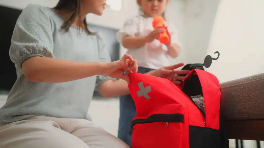 A mother packing an emergency backpack.