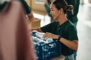 A volunteer passing out water bottles.