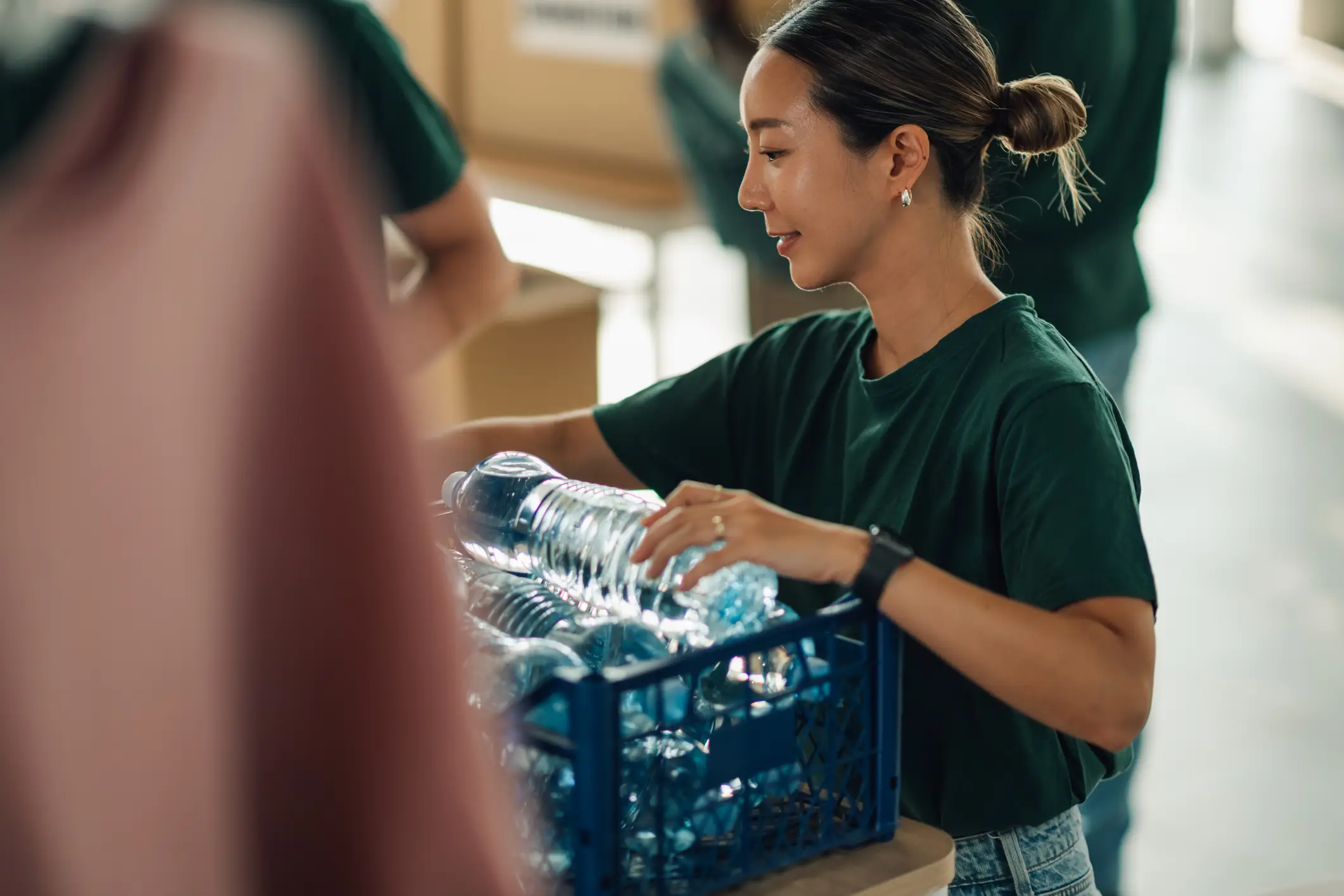 A volunteer passing out water bottles.