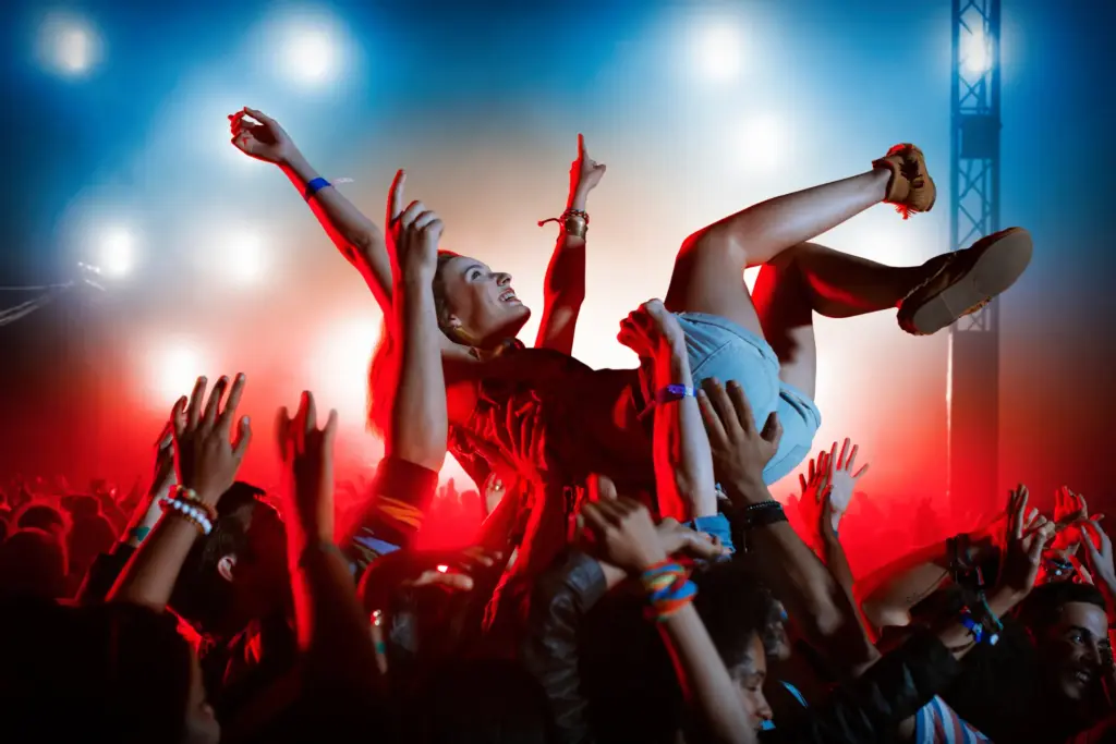 A girl crowd surfing at a music festival.