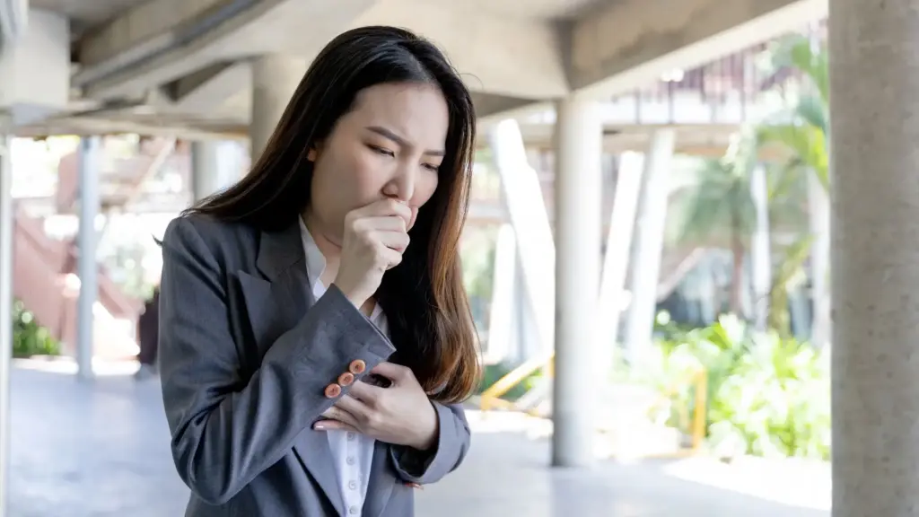 A woman coughing.
