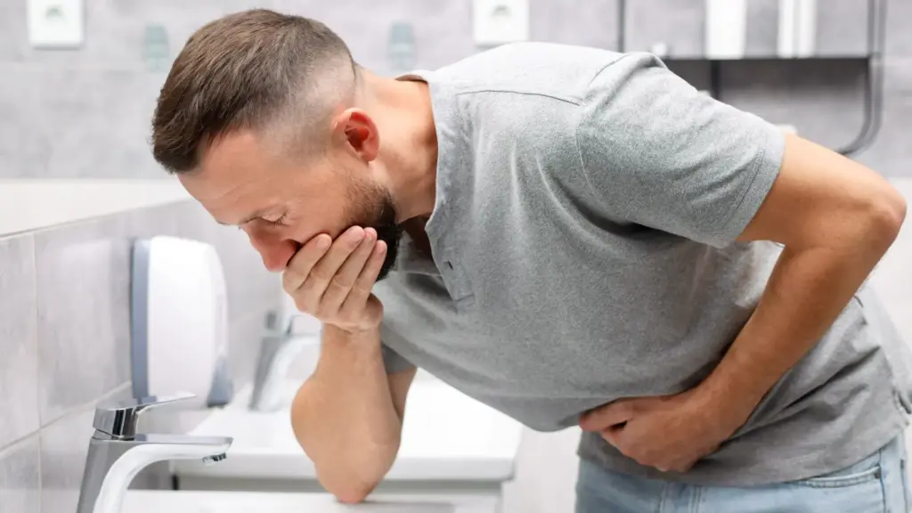 A man feeling intense nausea.