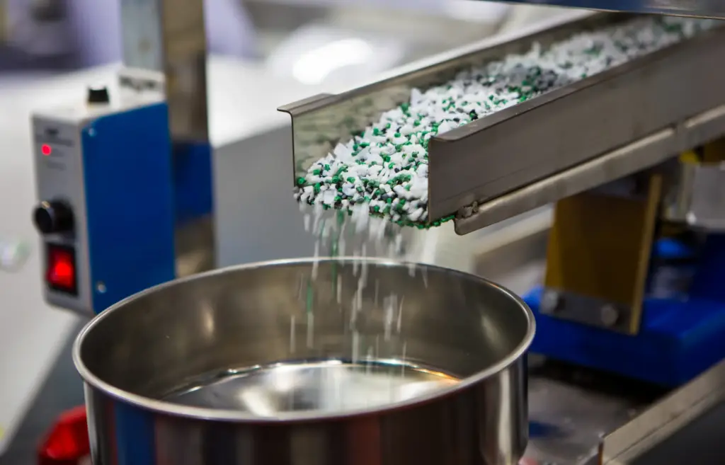 Microplastics being funneled into a container.